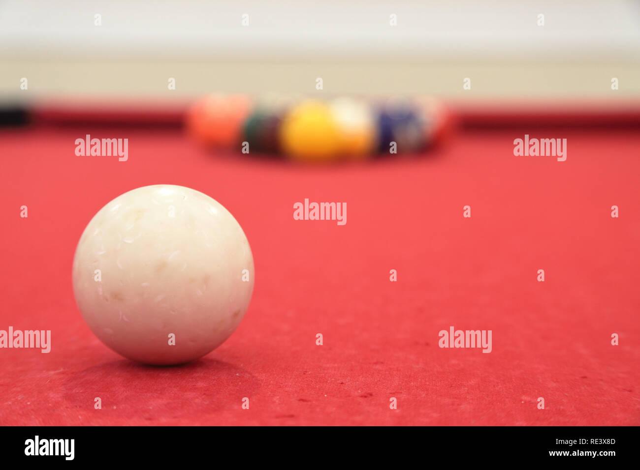 Billiards pool table with cue ball in focus, racked balls very out of foucs, shallow depth of field Stock Photo