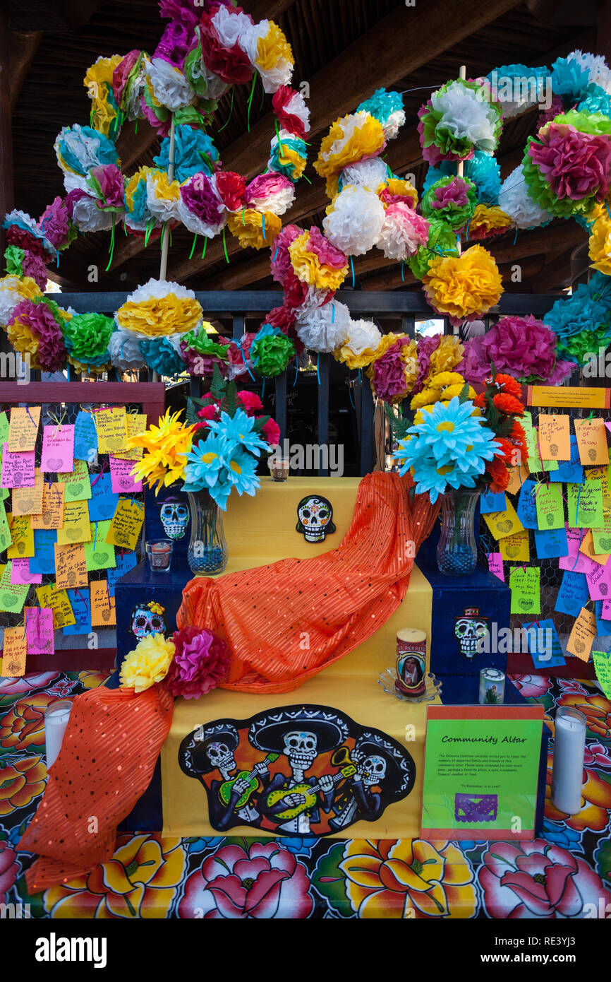 The community altar featuring colourful flowers and messages at the Dia