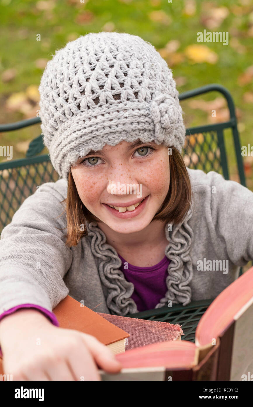 Young girl looks up from her books, Northeastern USA Stock Photo