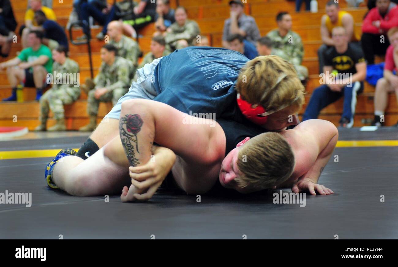 Sgt. Blake Solberg (top), a cannon crewmember with the 3-319th Airborne Field Artillery Regiment, and Sgt. Darren Bishop (bottom), a field artillery finder radar operator with the 3-319th Airborne Field Artillery Regiment, each tries to subdue the other while competing in an intramural wrestling tournament hosted by the Army Morale, Welfare and Recreation sports program Nov. 15, 2016 at Ritz Epps Fitness Center, Fort Bragg, N.C. Sports programs through the Fort Bragg MWR can be both unit and post-wide, which lets service members compete with warriors in and outside of their organized physical  Stock Photo