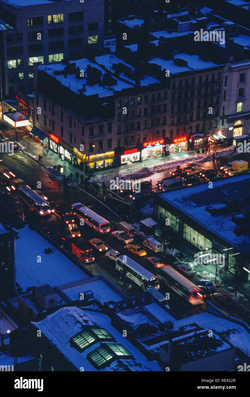 Traffic on a busy Manhattan intersection on a winter night in 1994, NYC, USA Stock Photo