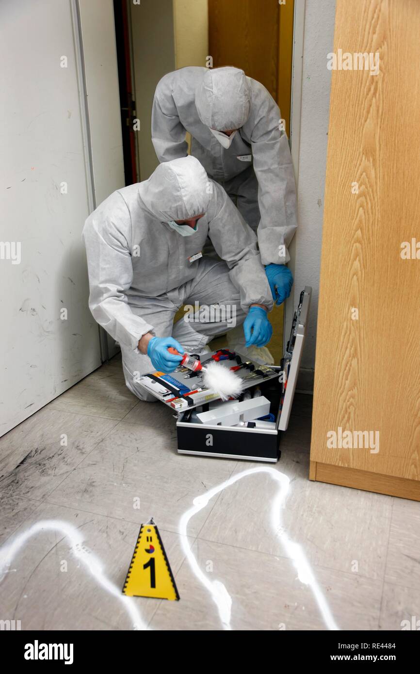 Forensic's case, officers of the C.I.D., the Criminal Investigation Department, gathering forensic evidence at the scene of a Stock Photo