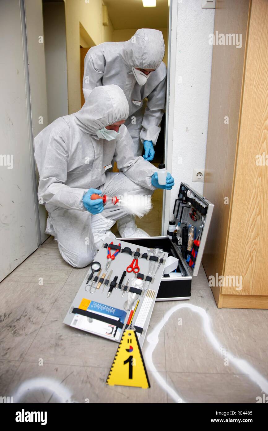 Forensic's case, officers of the C.I.D., the Criminal Investigation Department, gathering forensic evidence at the scene of a Stock Photo
