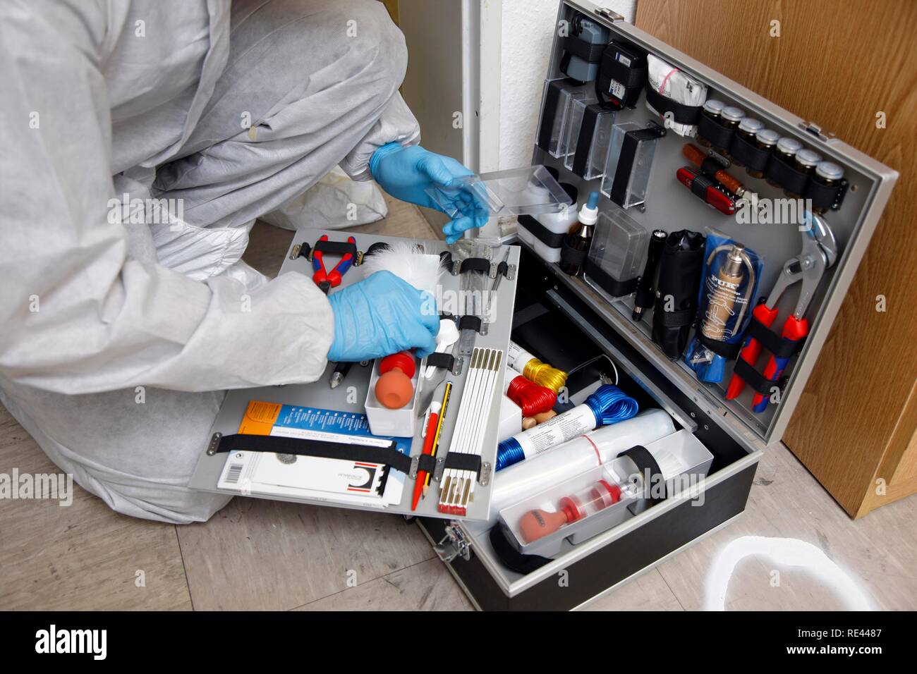 Forensic's case, officer of the C.I.D., the Criminal Investigation Department, gathering forensic evidence at the scene of a Stock Photo