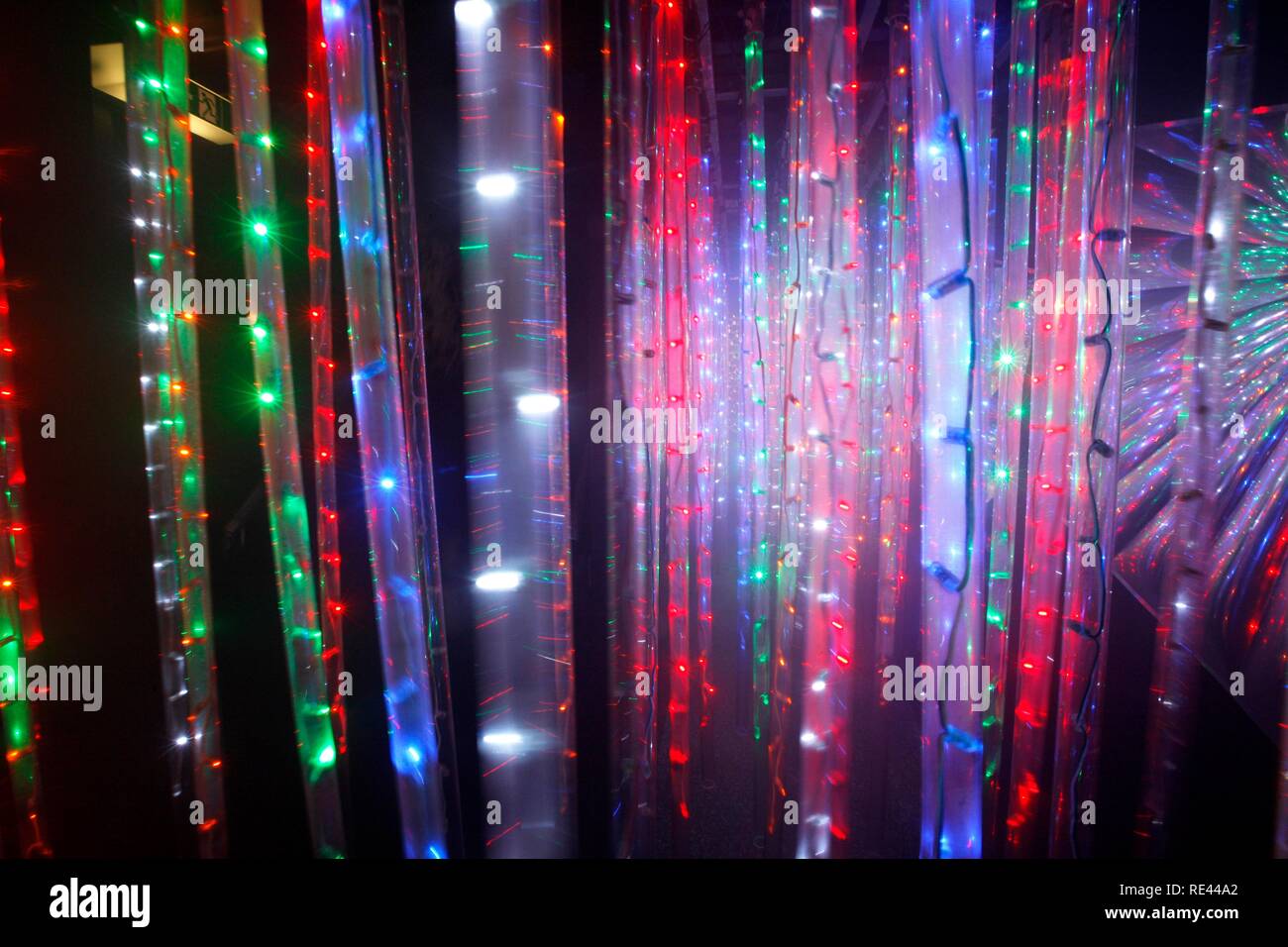 Maze, labyrinth made of colorful illuminated light rods, at a fair ...
