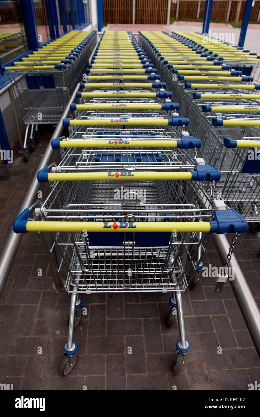 Shopping carts standing in a row in front of a supermarket Stock Photo