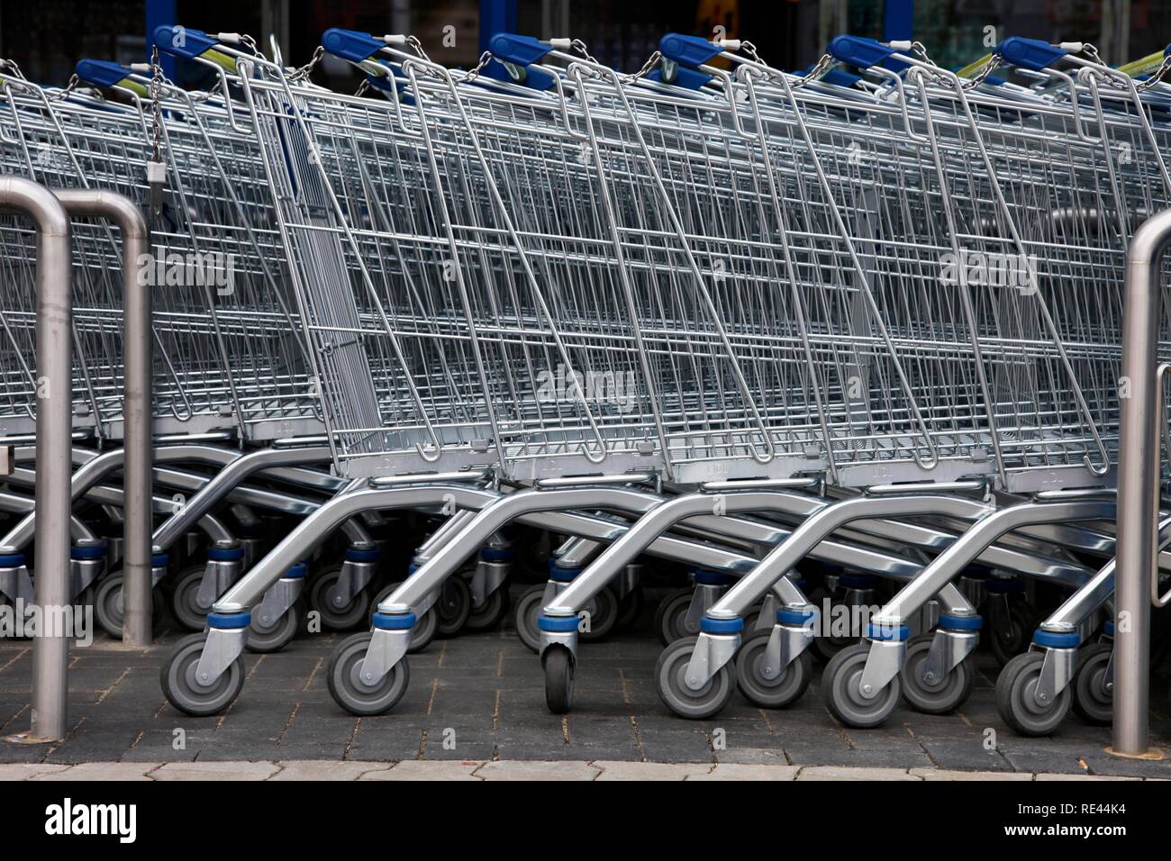 Shopping carts standing in a row in front of a supermarket Stock Photo