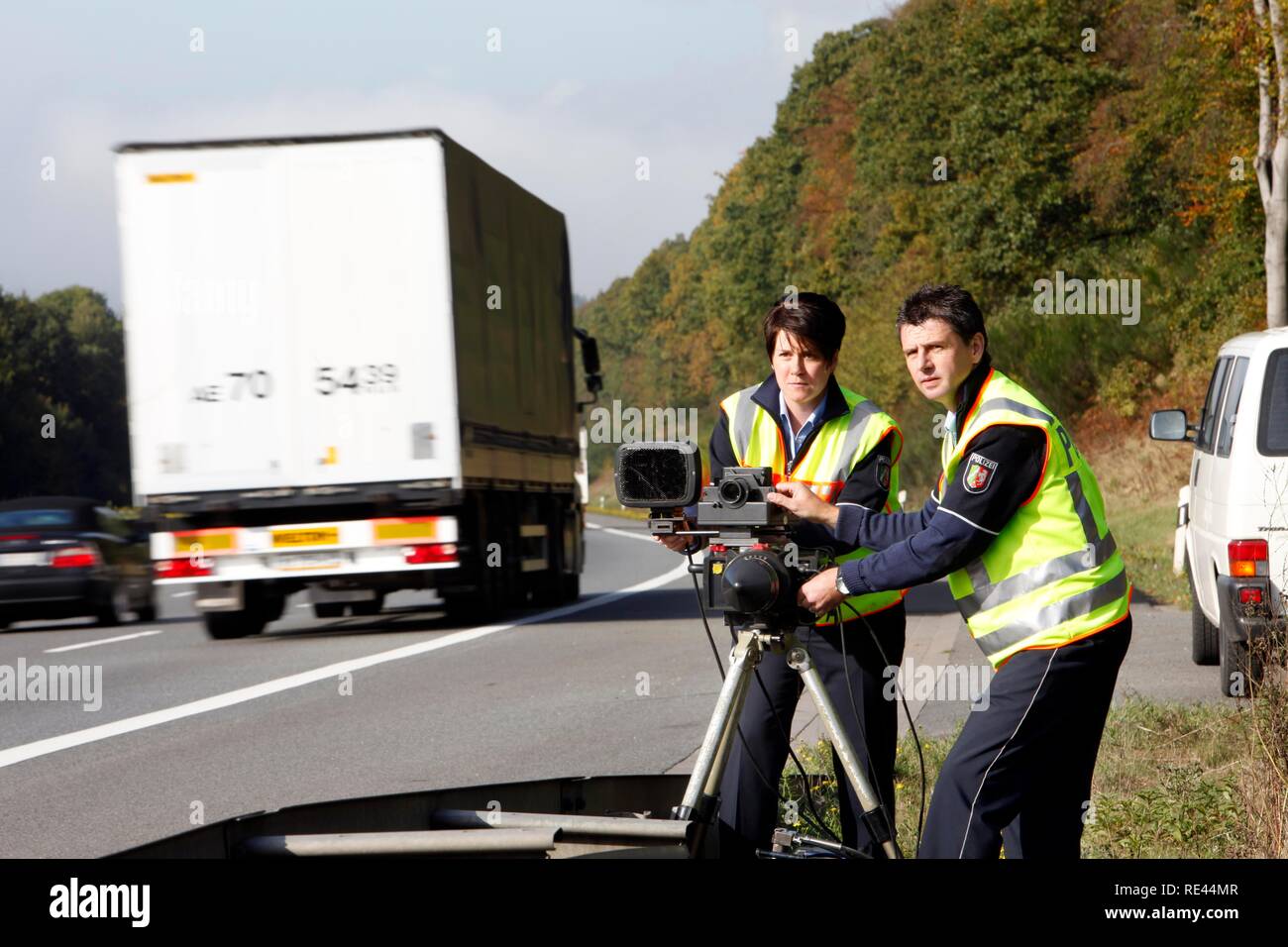 Police officers of the highway patrol errecting a radar measuring ...