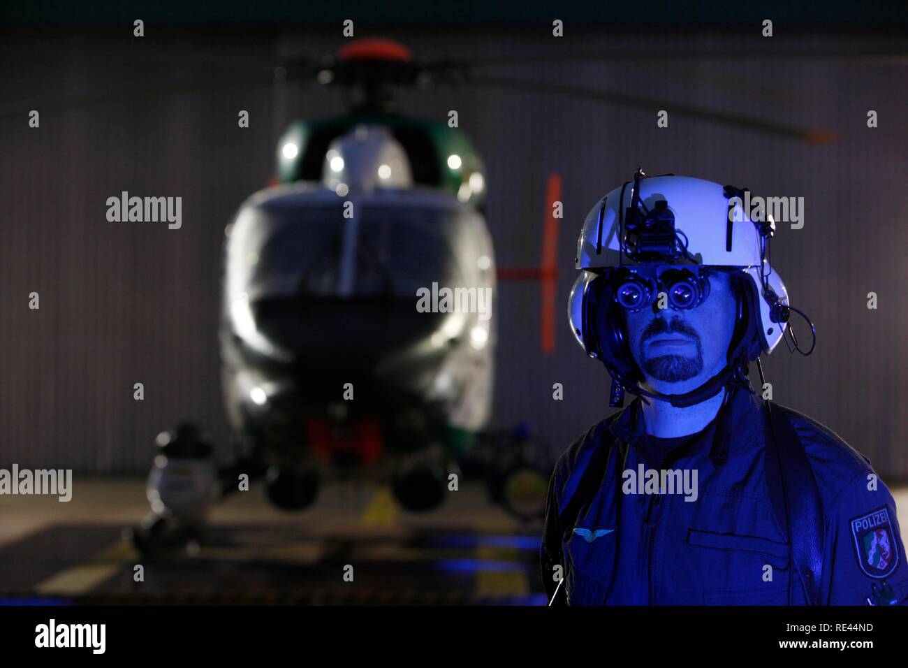 Patrol helicopter with night flying capability, image intensifier, infrared camera, pilot with night vision gear, night mission Stock Photo