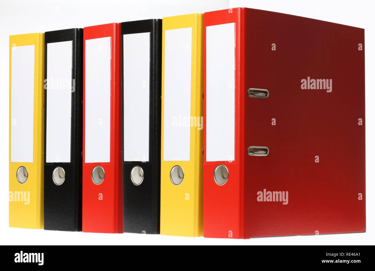 Black, yellow and red ring binders, blank labels Stock Photo