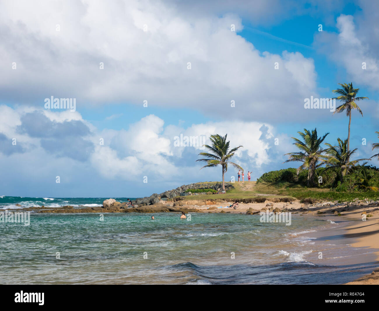 People relax on a beautiful beach in San Juan, Puerto Rico, on a warm and sunny day Stock Photo