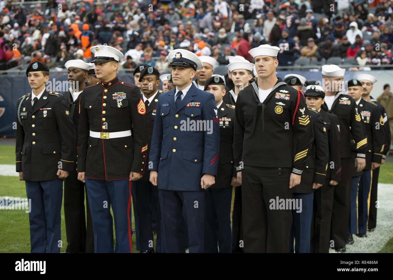 Service members from all five services stand in formation prior to a