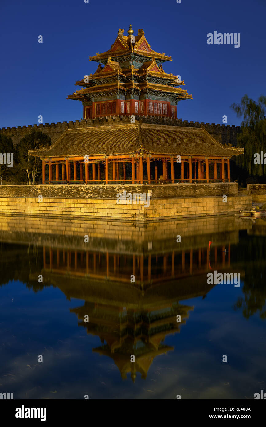 Beijing / China - October 10th 2018: Northwestern tower of the Forbidden City reflecting in the water moat during still night. Stock Photo