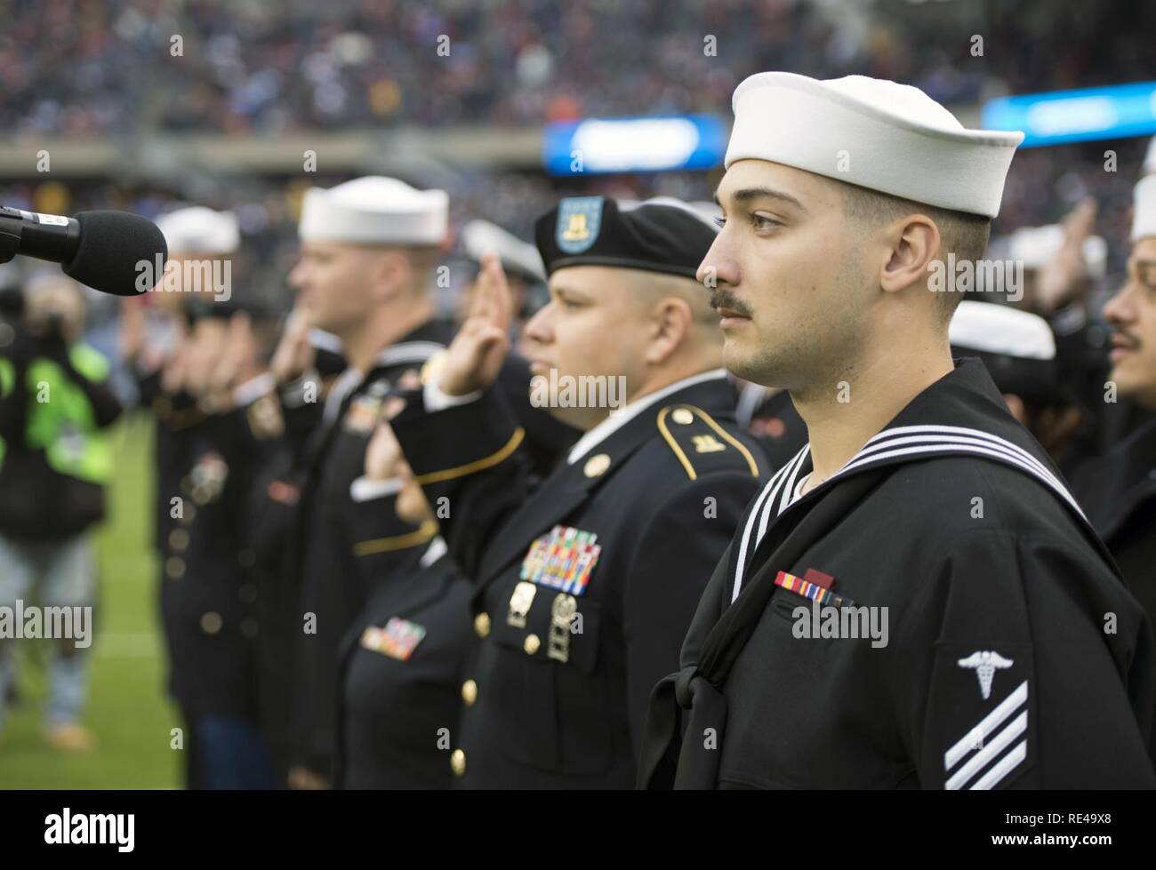 Service members from all five services stand in formation prior to a