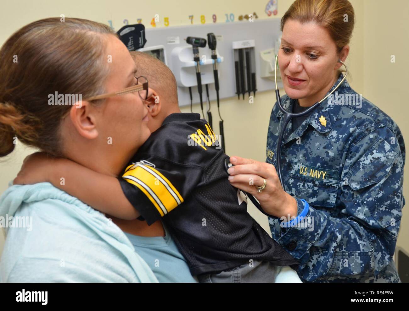 MAYPORT, Fla. (Nov. 10, 2016) – Capt. Mary White, a nurse practitioner at Naval Branch Health Clinic (NBHC) Mayport’s Pediatrics clinic, examines a child experiencing cold symptoms. NBHC Mayport is one of Naval Hospital Jacksonville’s six health care facilities located across Florida and Georgia. Of the clinics about 22,000 enrolled patients, more than 3,500 are enrolled at its Pediatrics clinic. Stock Photo