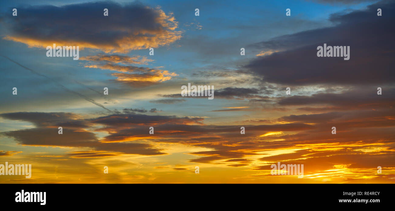 Sunset sky clouds in orange and blue background Stock Photo