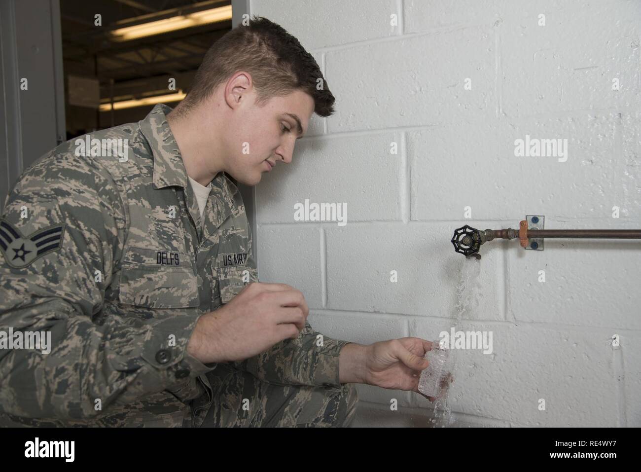 Senior Airman Alexander Delfs, 436th Aerospace Medicine Squadron bioenvironmental engineering journeyman, collects a water sample for bacteriologic testing Nov. 16, 2016, at an aircraft watering point on Dover Air Force Base, Del. Members of the 436th AMDS bioenvironmental engineering flight send water samples to a laboratory to test for the presence of harmful bacteria in drinking water. Stock Photo