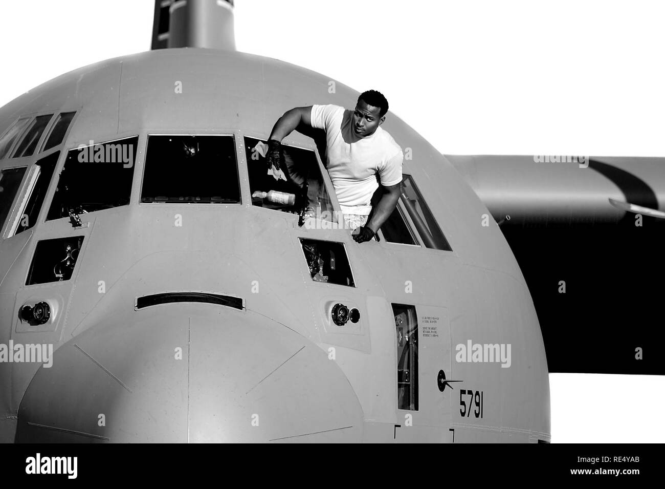 A U.S. Air Force crew chief assigned to the 19th Aircraft Maintenance Squadron, cleans the windows on a C-130J Super Hercules at Little Rock Air Force Base, Ark., Nov. 16, 2016. The C-130 primarily performs the tactical portion of the airlift mission. The aircraft is capable of operating from rough, dirt strips and is the prime transport for airdropping troops and equipment into hostile areas. Stock Photo