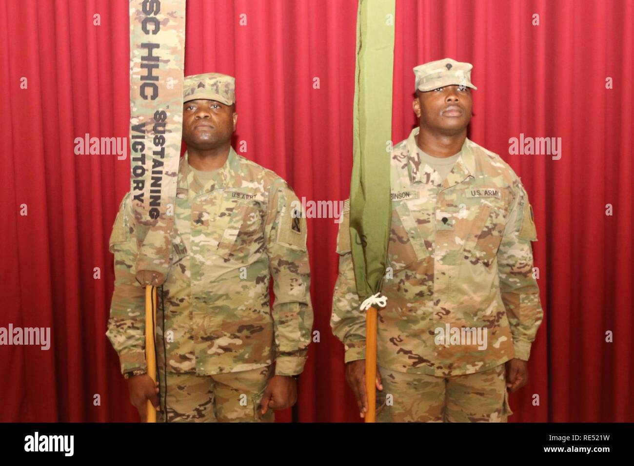 Soldiers of the 184th Sustainment Command and 143d Sustainment Command stand with guidons during the transfer of authority ceremony Jan. 2, 2019, at Camp Arifjan, Kuwait. Stock Photo