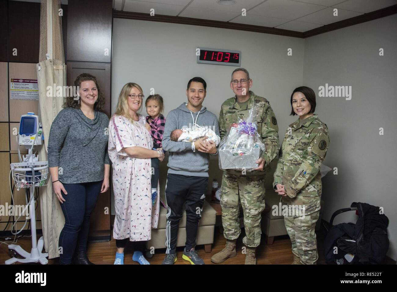 Brig. Gen. George N. Appenzeller, Brooke Army Medical Center commander, along with Sarah Kelly, BAMC auxiliary president, and Master Sgt. Melinda Griffin, enlisted advisor to the deputy chief for patient support, present a gift basket to retired Army Sgt. Christopher and Hillary Hunt after the birth of their son, Callum Charles Hunt, at BAMC, Fort Sam Houston, Texas, Jan. 2, 2019. Callum, born at 1:50 a.m. on New Year’s Day, was BAMC first baby born in 2019. Stock Photo