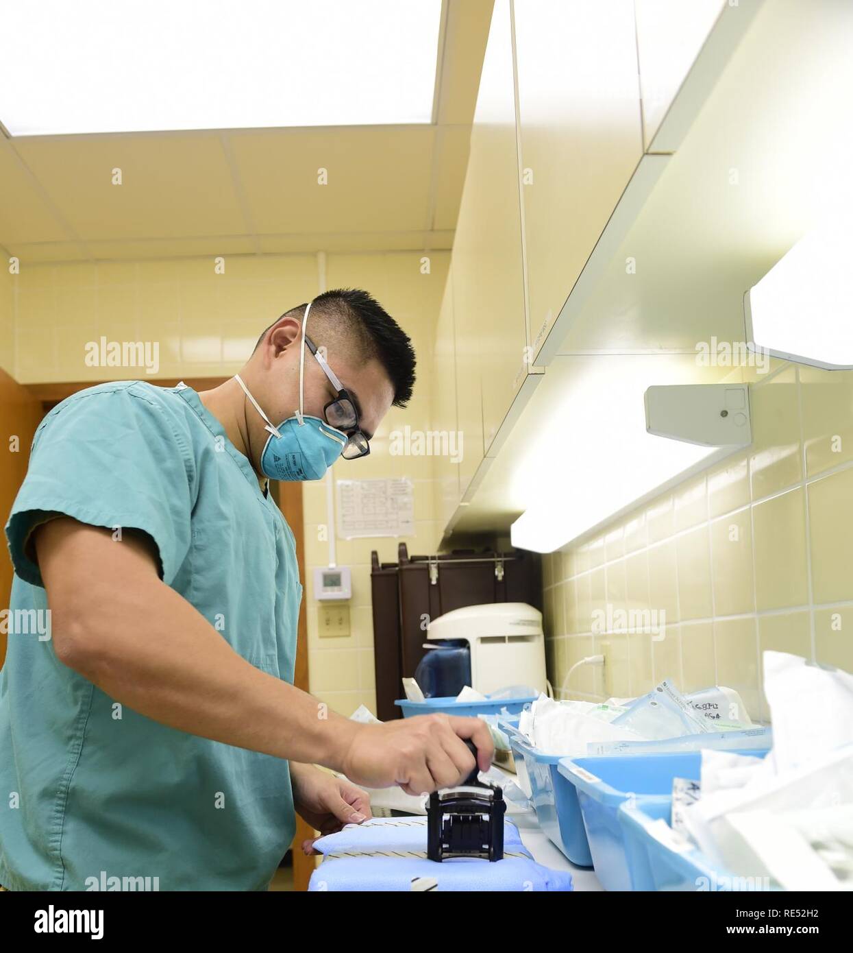 OKINAWA, Japan (Jan. 2, 2019) Hospital Corpsman 3rd Class Julio Domingo, assigned to Naval Mobile Construction Battalion (NMCB) 3, stamps the packaging of sterilized dental tools. NMCB-3 is forward deployed throughout the Indo-Pacific region and United States ready to support major combat operations, theater security, humanitarian assistance and disaster relief operations. Stock Photo