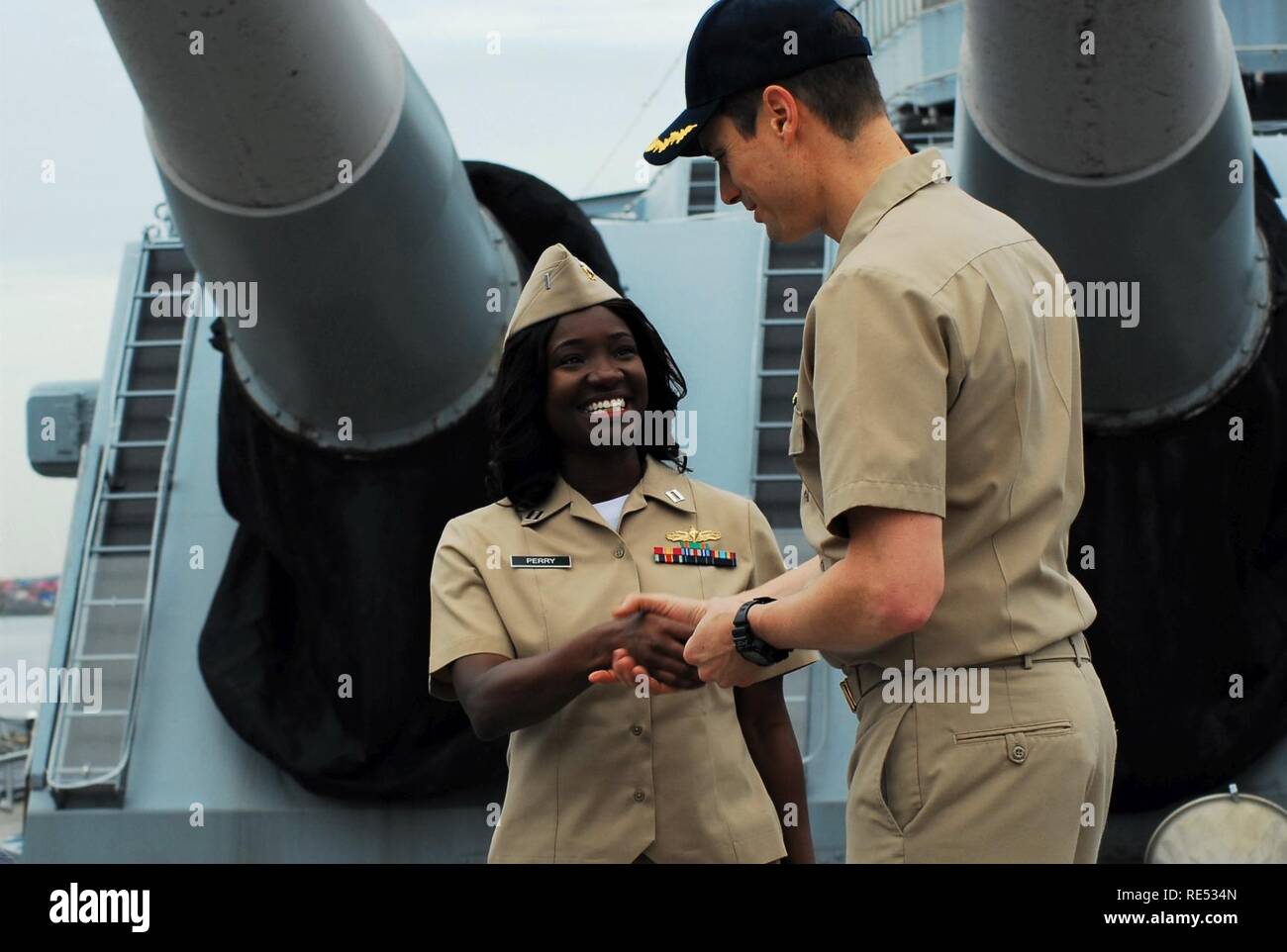 CDR Ethan Rule, Commanding Officer of the USS Tortuga (LSD 46) congratulates newly promoted LT Latina Perry during a promotion ceremony aboard the USS Wisconsin (BB 64). Stock Photo