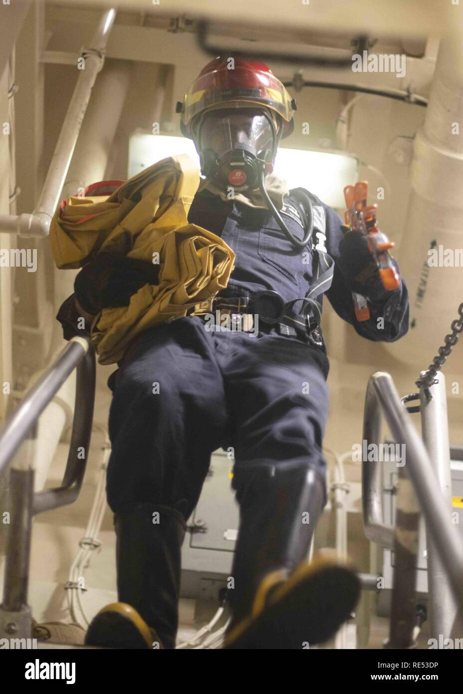 MEDITERRANEAN SEA (Jan. 4, 2019) Boatswain’s Mate 1st Class Ivan Godinez responds to a simulated fire during a damage control drill aboard amphibious transport dock ship USS Arlington (LPD 24). Arlington is making a scheduled deployment as part of the Kearsarge Amphibious Ready Group in support of maritime security operations, crisis response and theater security cooperation, while also providing a forward naval presence. Stock Photo