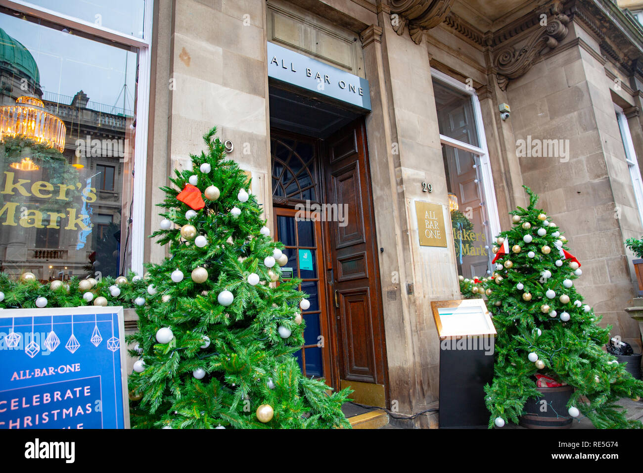 Christmas trees outside the entrance to an All Bar One pub in Edinburgh,Scotland,UK Stock Photo