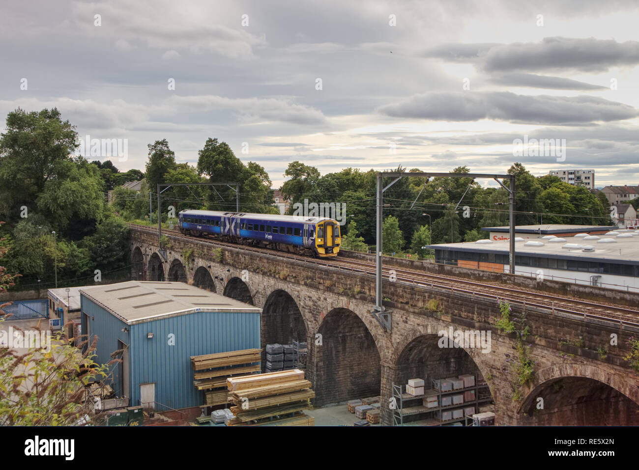 Edinburgh, Scotland / United Kingdom - August 4 2018: A Scotrail train British Rail DMU Class 158 Express Sprinter is travelling at speed over an old Stock Photo