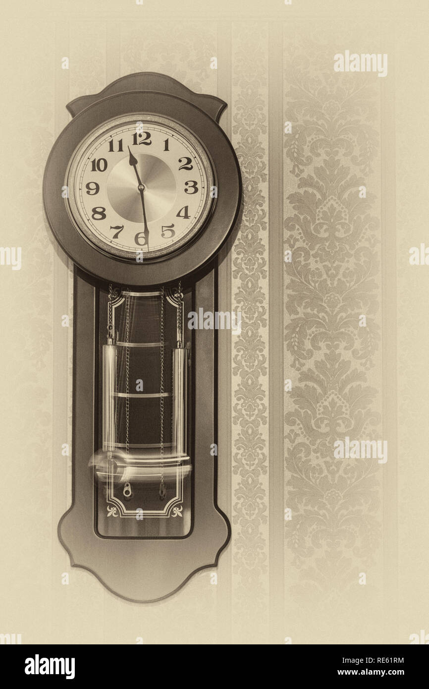 Wall pendulum clock with the fight in the old style. Stock Photo