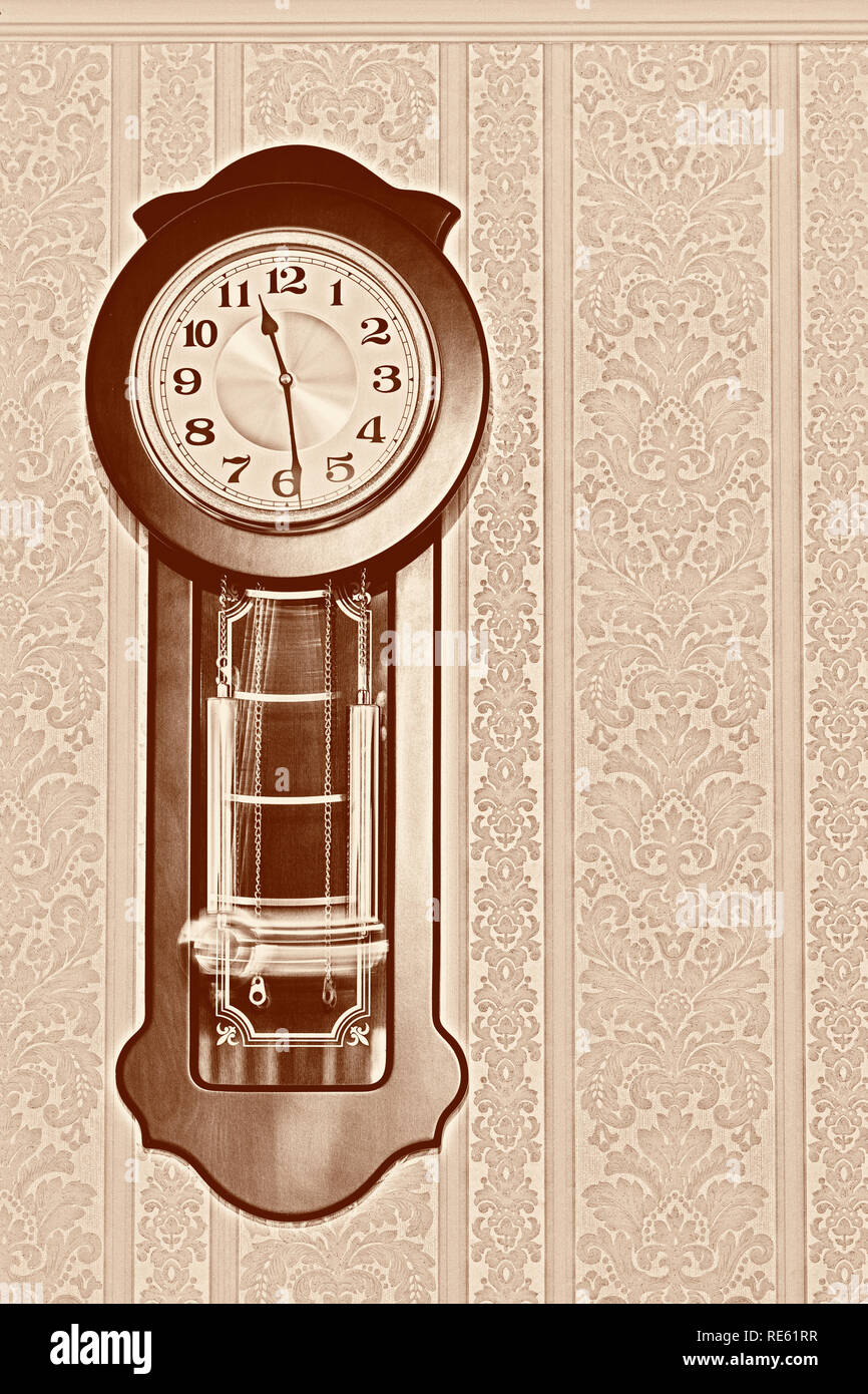 Wall pendulum clock with the fight in the old style. Stock Photo