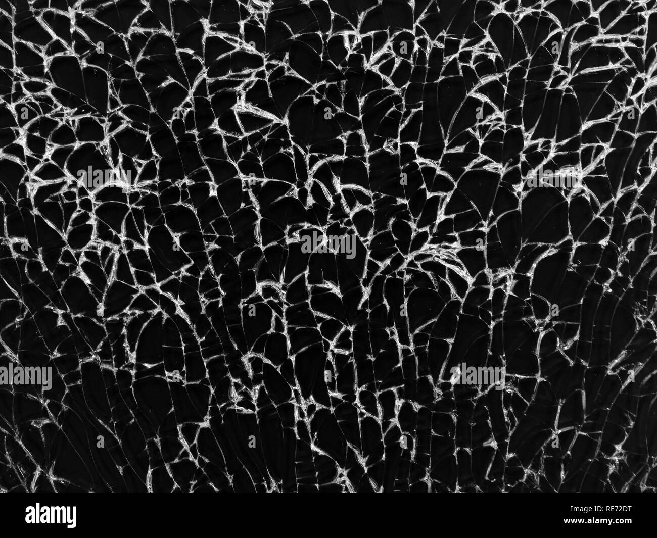 Cracked glass texture on black background. Isolated realistic cracked glass effect. Stock Photo