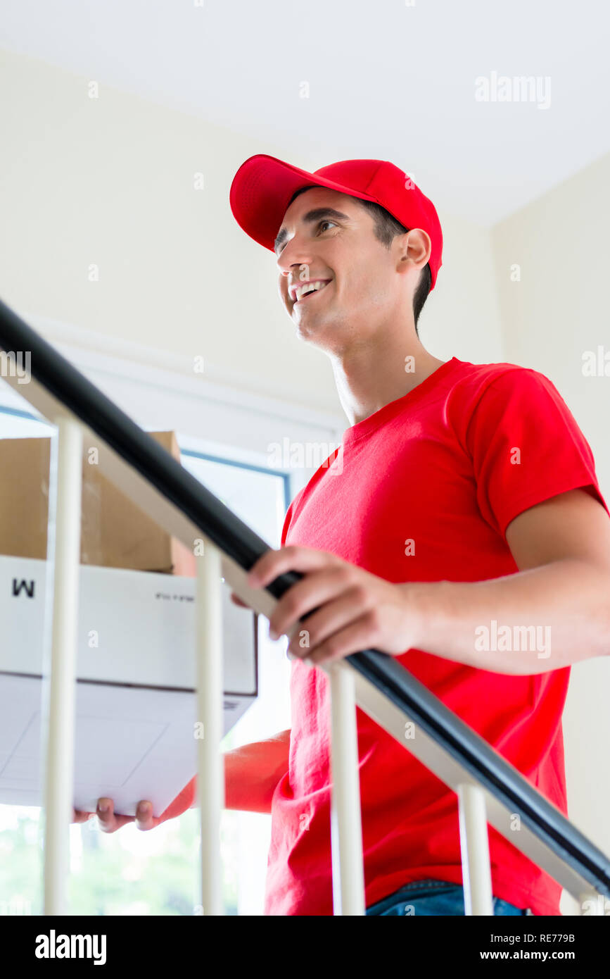 Man in red uniform delivering mail post boxes Stock Photo Alamy