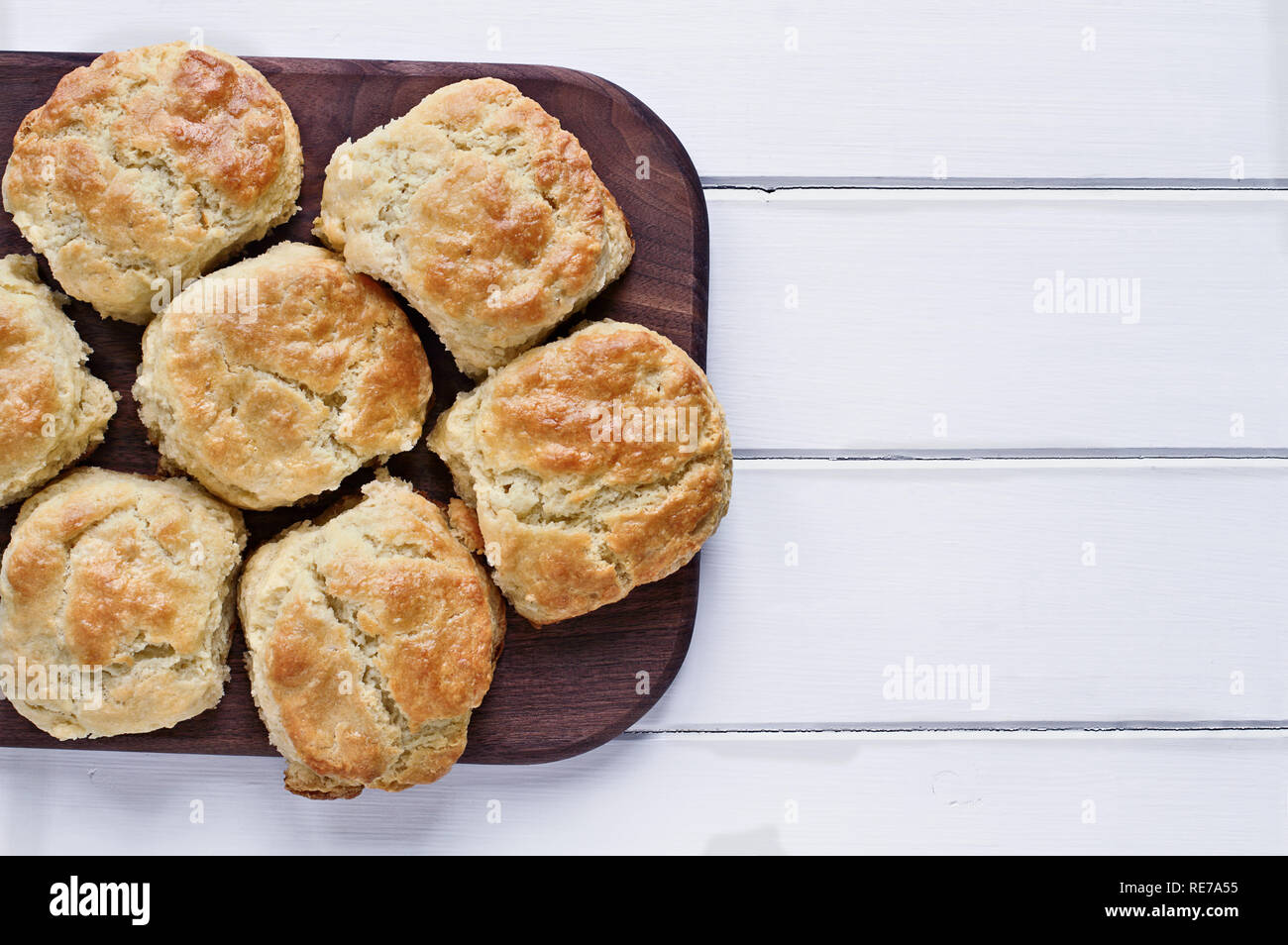 Fresh buttermilk southern biscuits or scones over a white table shot from above. Top view. Stock Photo
