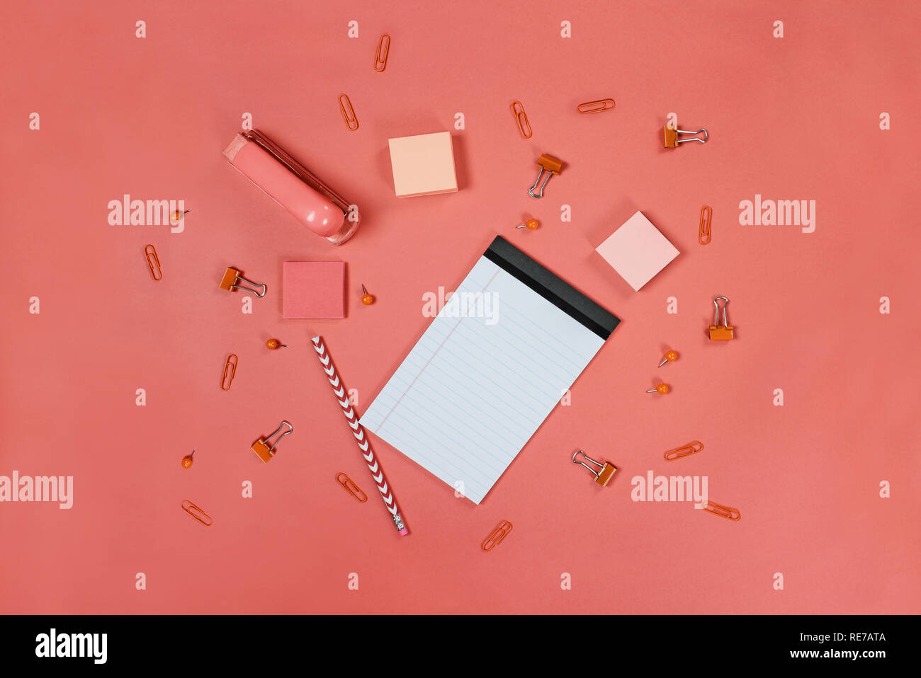 Blank White Note Pad Paper Pencil Stapler Thumb Tacks Paper Clips And Adhesive Paper Over Coral Color Background With Free Space For Text Image Stock Photo Alamy