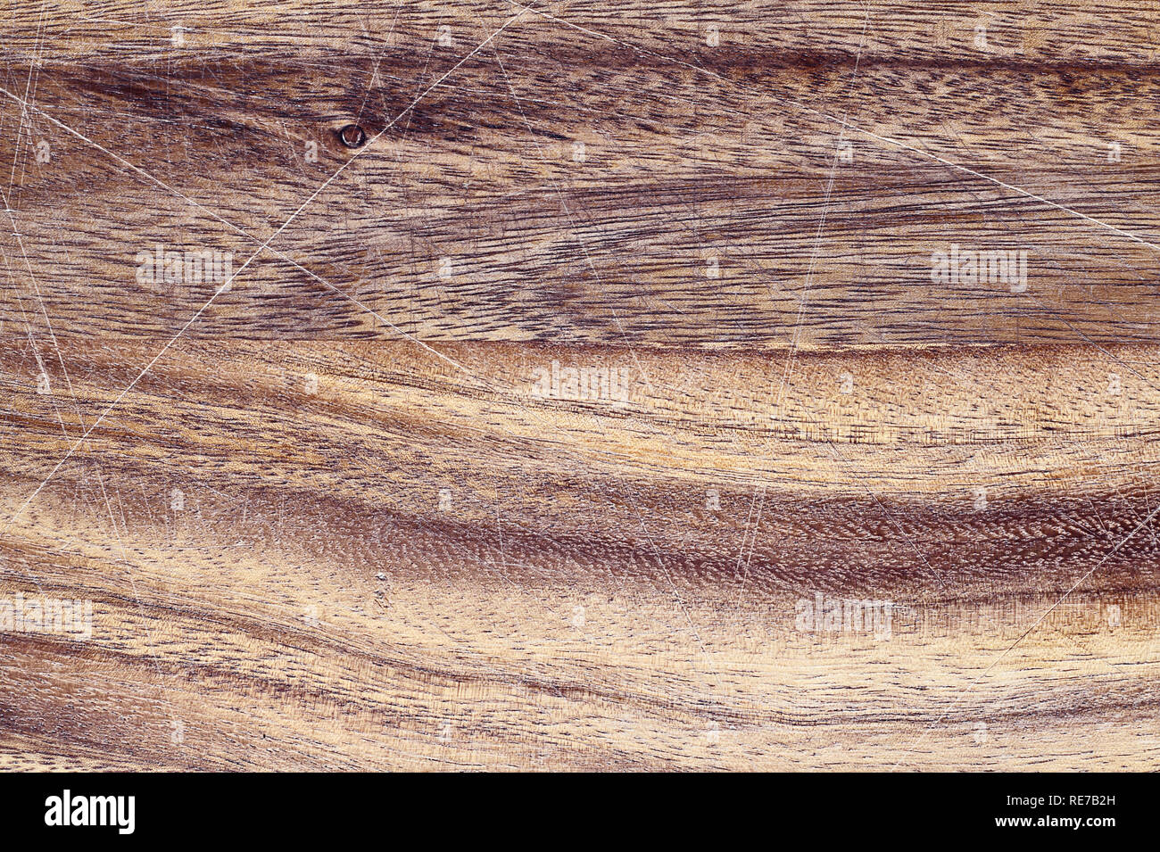 Vintage wooden cutting board with scratches. Image shot from above in