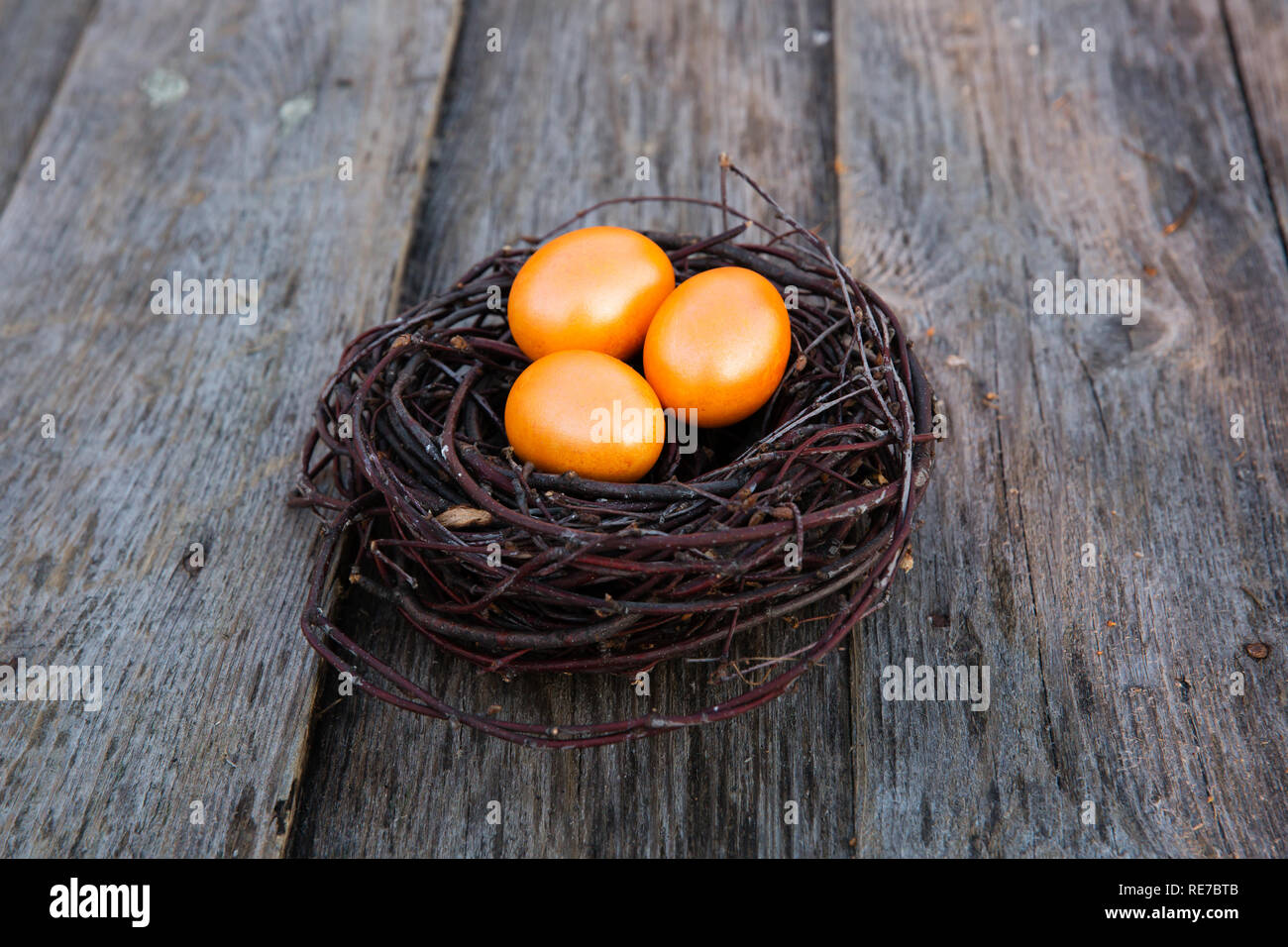 Colorful Easter eggs in the nest on wooden background Stock Photo - Alamy