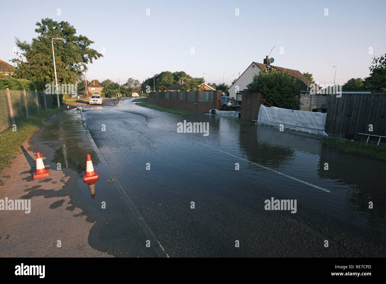 Flooded road due to burst water main Ringwood Hampshire England UK