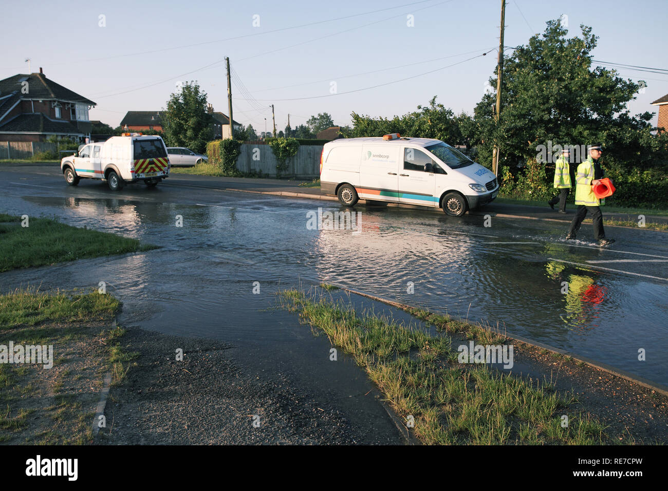 Flooded road due to burst water main Ringwood Hampshire England UK Stock Photo