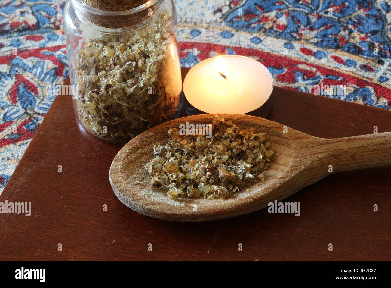 Natural aromatic musk incense on an old kitchen spoon in a Arab environment. Selective focus on spoon Stock Photo