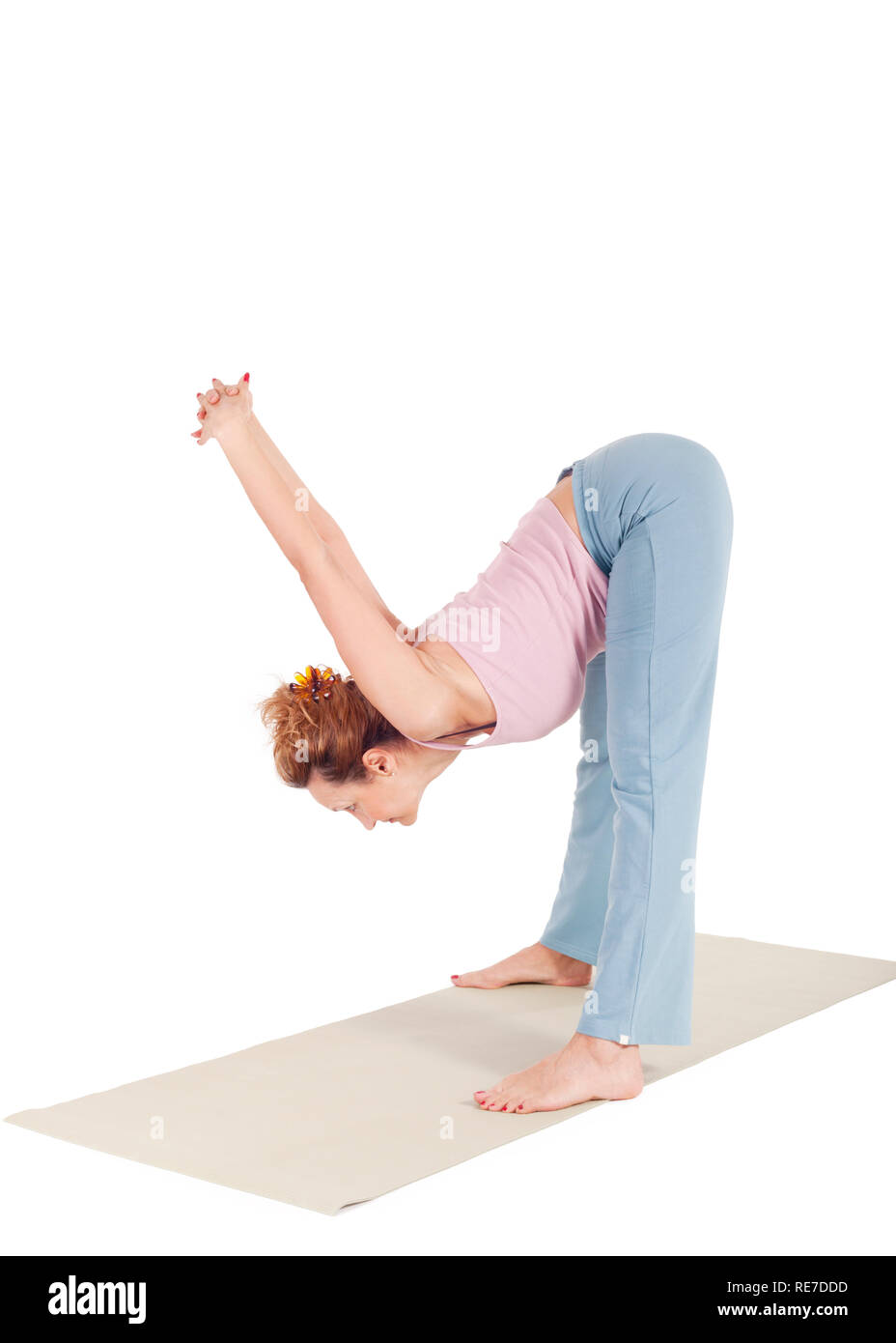 Slim woman doing yoga in Wide Legged Forward Bend pose · Free