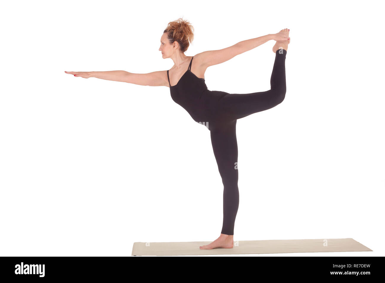 Beautiful Yoga: Lord of Dance Pose - Real senior woman practitioner doing Natarajasana exercise Stock Photo