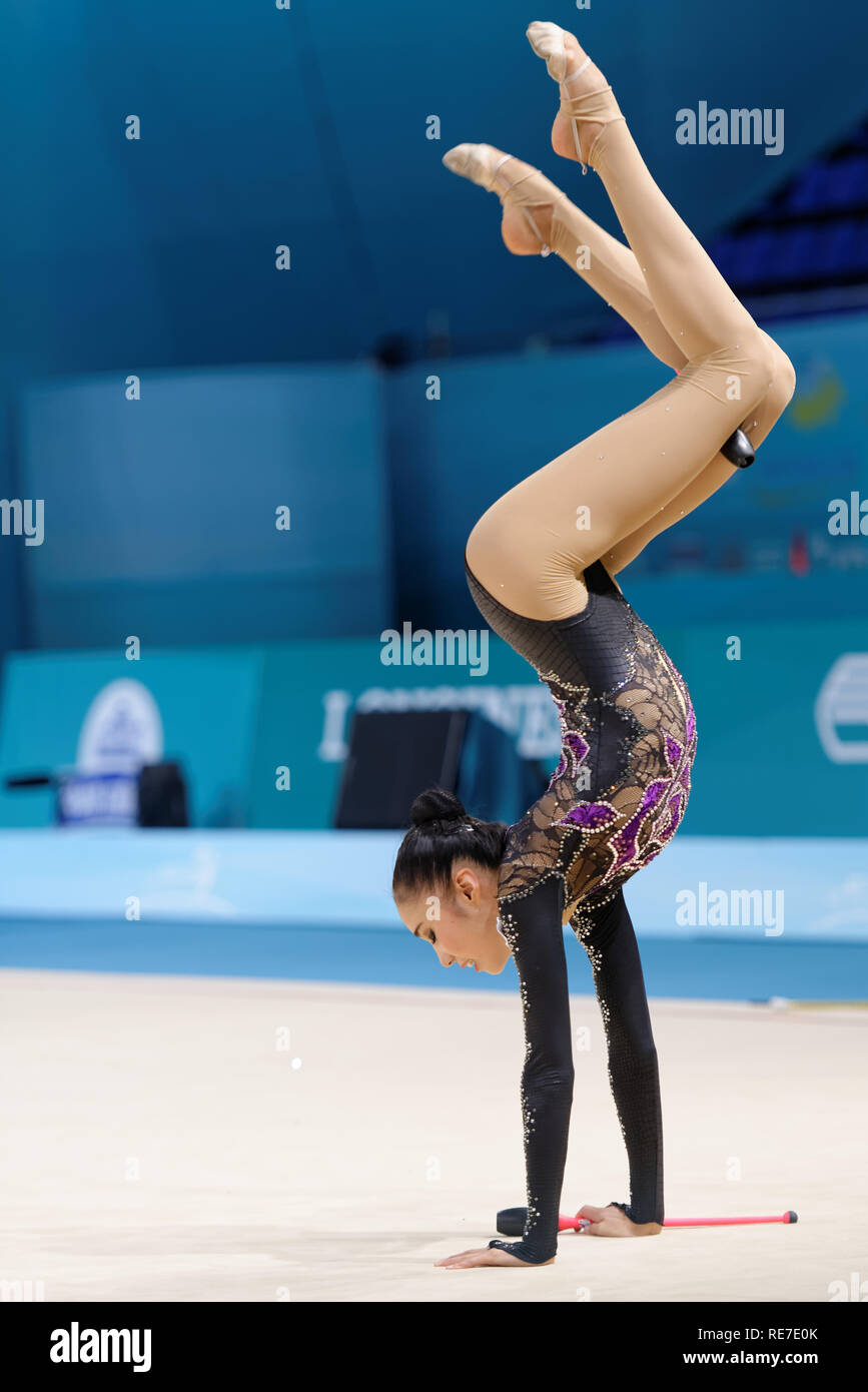 Kiev, Ukraine - August 29, 2013: Unidentified female gymnast performs with clubs during 32nd Rhythmic Gymnastics World Championships. The event is hel Stock Photo