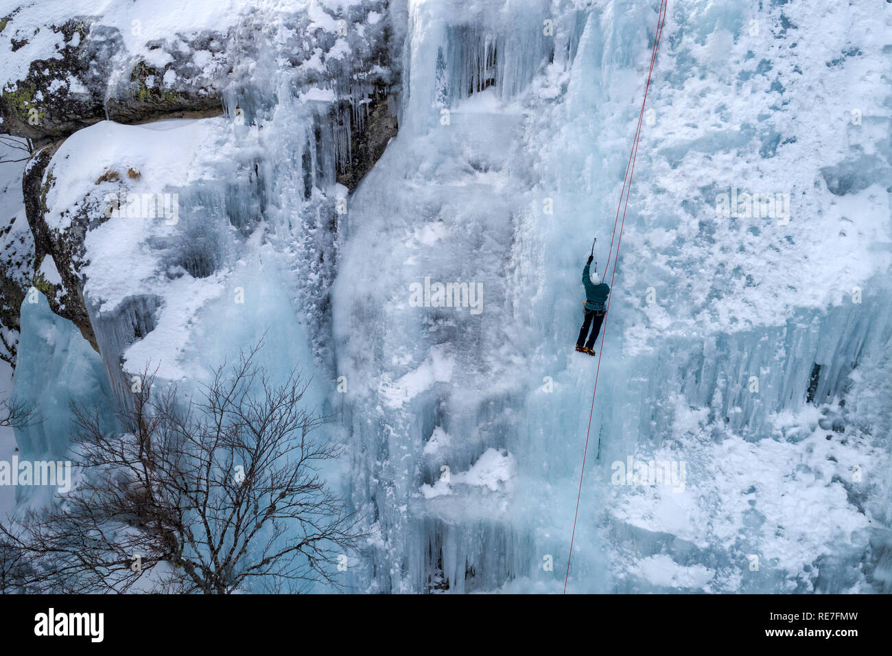 Alone man climbing rope hi-res stock photography and images - Alamy