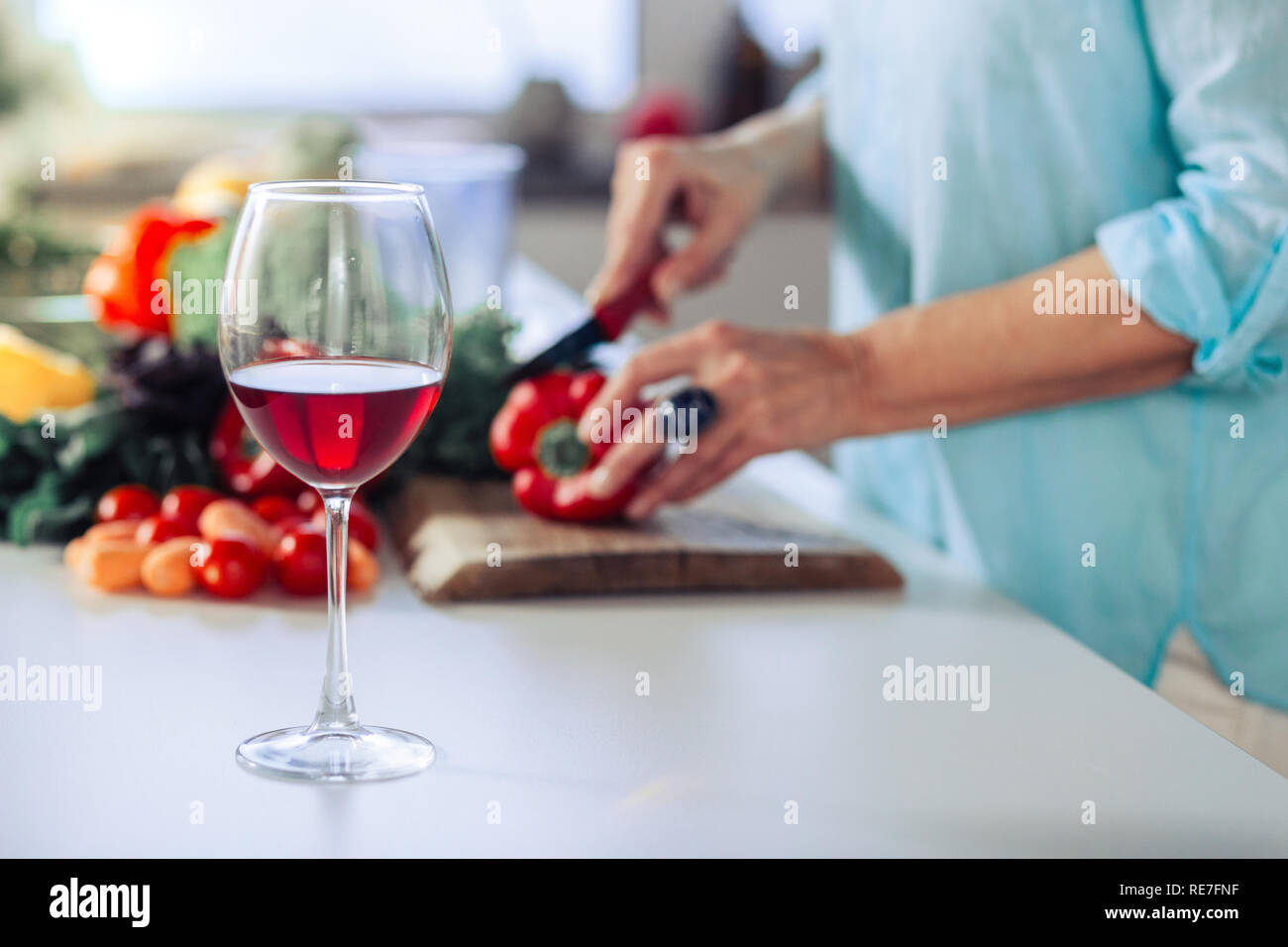 Glass with dry red wine standing on the table Stock Photo