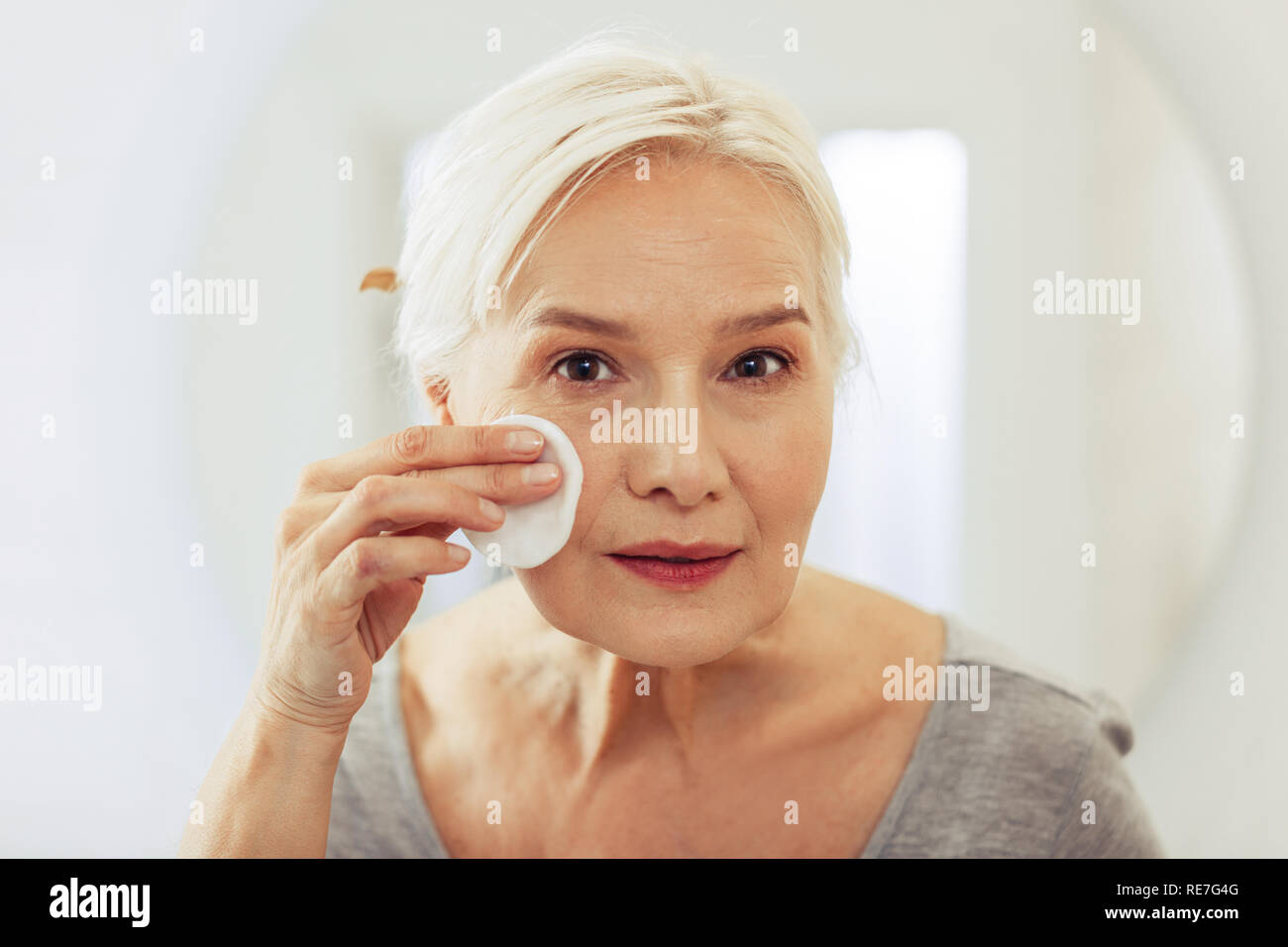 Mature woman cleansing face hi-res stock photography and images - Alamy