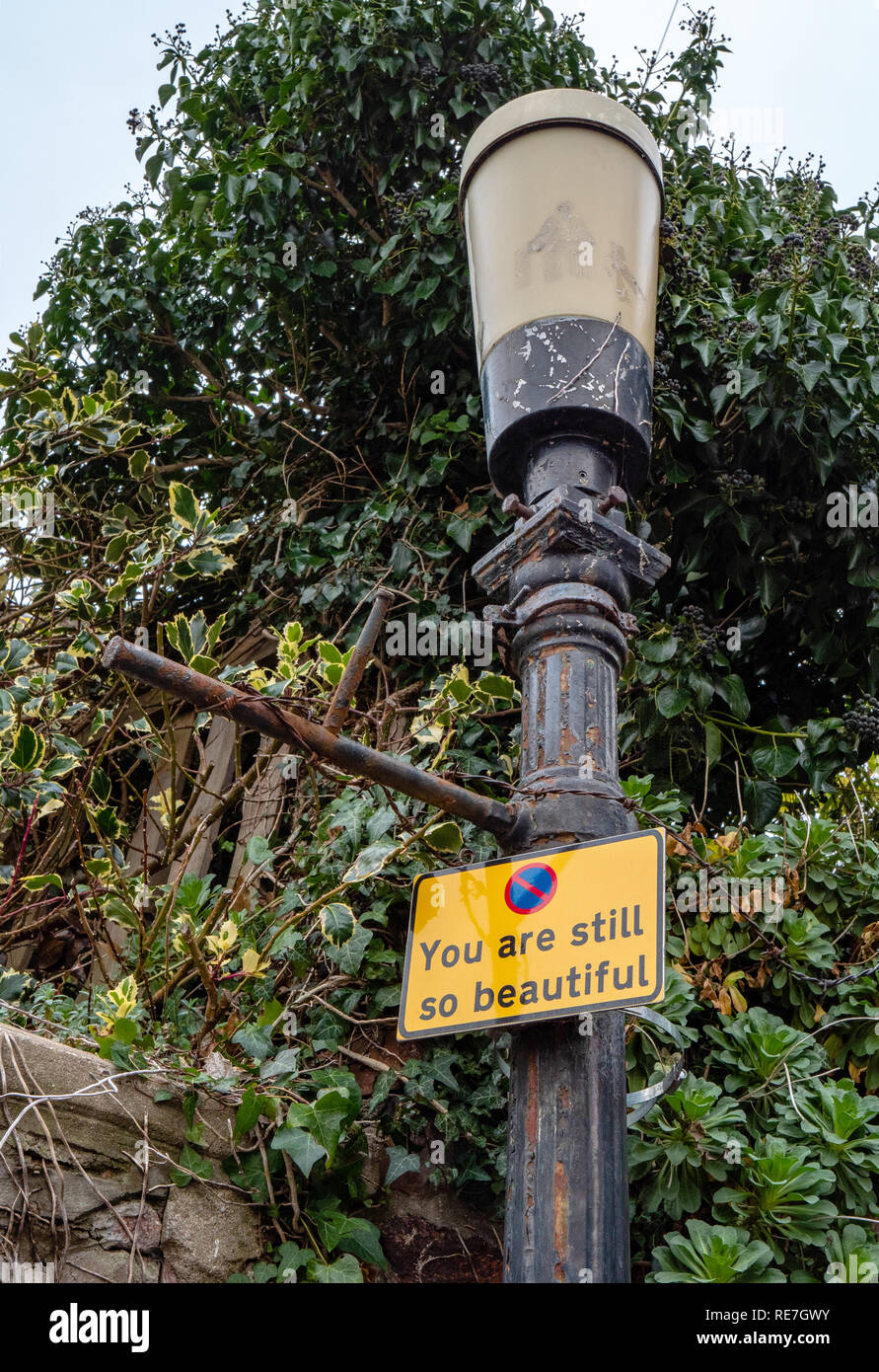 Encouraging message with a no parking at any time street sign on a Bristol UK street lamp saying ' you are still so beautiful ' Stock Photo