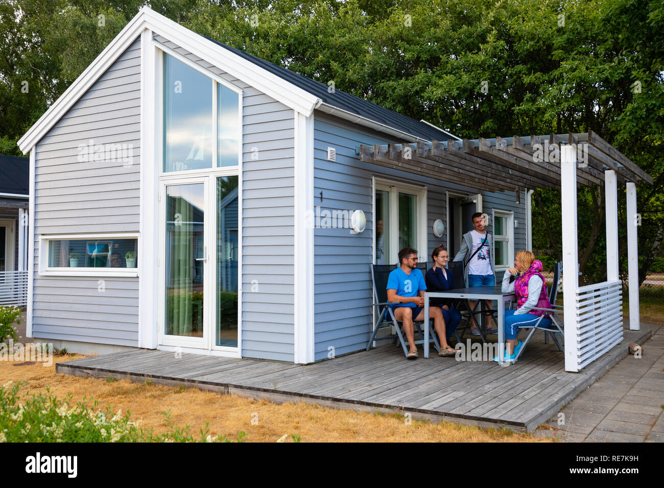 Raa, Sweden 17.06.2018 Group of people in grey camping cabins in