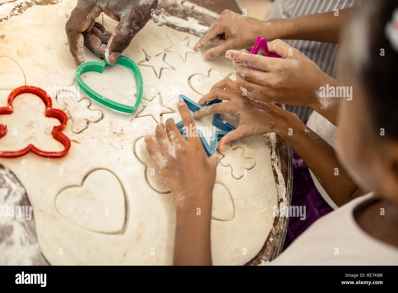 Top view of happy family forming cookies all together Stock Photo