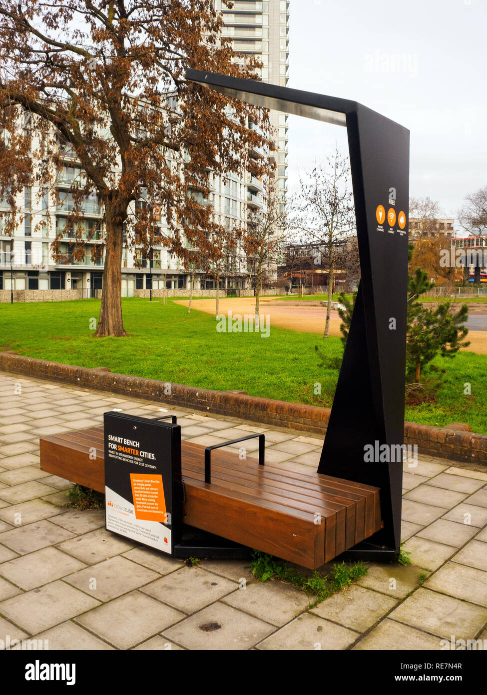 Public solar-powered 'smart bench' for charging mobile devices and wi-fi internet connection in Deptford - London, England Stock Photo
